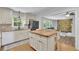 Open kitchen with an island, stainless steel refrigerator, and a view into the living room at 4420 Lake Breeze Dr, Stone Mountain, GA 30083
