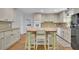 Bright kitchen featuring granite countertops, stainless steel appliances, and a charming kitchen island at 4420 Lake Breeze Dr, Stone Mountain, GA 30083