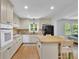 Updated kitchen with white cabinets, a kitchen island, and modern appliances at 4420 Lake Breeze Dr, Stone Mountain, GA 30083
