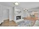 Open floor plan living room with hardwood floors, a fireplace, and an island looking into the kitchen at 4420 Lake Breeze Dr, Stone Mountain, GA 30083