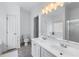 Bright bathroom with double vanity, neutral tile floors, and a large mirror at 6045 Park Close, Fairburn, GA 30213