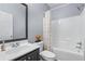 Bathroom featuring a single sink vanity, a tub/shower combination, and neutral walls at 6045 Park Close, Fairburn, GA 30213