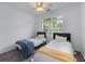 Bedroom featuring two twin beds, neutral walls, and a window with natural light at 6045 Park Close, Fairburn, GA 30213