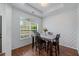 Bright dining room with large window, wood floors, and stylish wallpaper at 6045 Park Close, Fairburn, GA 30213
