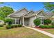Attractive home exterior with well-maintained landscaping and a walkway to the front door at 6045 Park Close, Fairburn, GA 30213