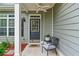 Charming front porch with gray siding and a seating area at 6045 Park Close, Fairburn, GA 30213