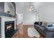 Bright living room with a fireplace, ceiling fan, and gray sofa at 6045 Park Close, Fairburn, GA 30213