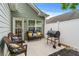 Cozy outdoor patio space with seating, a grill, and a white privacy fence at 6045 Park Close, Fairburn, GA 30213