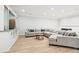 Finished basement featuring light wood floors, a large sectional sofa, and built-in shelving at 2685 Grady Se St, Smyrna, GA 30080