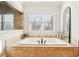Bright bathroom with a white soaking tub and window at 2685 Grady Se St, Smyrna, GA 30080