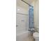 Bright bathroom featuring a shower-tub with a decorative shower curtain and tiled surround at 2685 Grady Se St, Smyrna, GA 30080