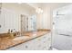 Bathroom with granite countertop, dual sinks, and a large mirror at 2685 Grady Se St, Smyrna, GA 30080