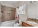 Cozy bathroom with a tiled shower/tub, granite countertop sink, and natural light at 2685 Grady Se St, Smyrna, GA 30080