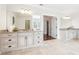 Bathroom featuring dual sink vanities, mirrors, and tile floors at 2685 Grady Se St, Smyrna, GA 30080