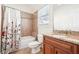Bathroom featuring a tiled shower/tub combination and a wooden vanity with granite countertop at 2685 Grady Se St, Smyrna, GA 30080