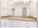 Bathroom vanity with granite countertop, dual sinks, and a large mirror at 2685 Grady Se St, Smyrna, GA 30080