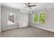 Sunlit bedroom with gray walls, carpet floors, ceiling fan and large windows at 2685 Grady Se St, Smyrna, GA 30080
