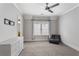 Bright bedroom featuring neutral carpeting, a modern ceiling fan, and a comfortable seating area at 2685 Grady Se St, Smyrna, GA 30080