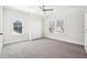 Bright bedroom featuring carpeted floors, ceiling fan, and dresser for ample storage at 2685 Grady Se St, Smyrna, GA 30080