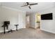 Well-lit bedroom featuring plush carpet, ceiling fan, desk, and easy access to the bathroom at 2685 Grady Se St, Smyrna, GA 30080