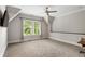 Large bedroom with a dormer window, plush carpeting, and a built-in desk area at 2685 Grady Se St, Smyrna, GA 30080
