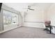 Bedroom with large window, ceiling fan, plush carpet, and a workspace with desk at 2685 Grady Se St, Smyrna, GA 30080