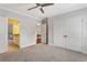 Bright bedroom featuring gray walls, carpet floors, ceiling fan and ensuite access at 2685 Grady Se St, Smyrna, GA 30080