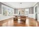 Bright dining room with large windows, hardwood floors, and modern wooden dining set at 2685 Grady Se St, Smyrna, GA 30080