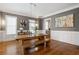 Bright dining room features a wooden table and bench, hardwood floors, and neutral paint at 2685 Grady Se St, Smyrna, GA 30080