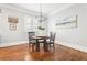 Eating area with hardwood floors, light gray walls, a modern chandelier, and natural light at 2685 Grady Se St, Smyrna, GA 30080