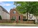Charming two-story home with a brick facade and a well-manicured front yard and a wooden fence at 2685 Grady Se St, Smyrna, GA 30080