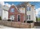 Charming two-story home featuring a unique brick facade and a well-maintained fenced front yard at 2685 Grady Se St, Smyrna, GA 30080
