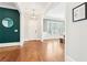 Inviting foyer with hardwood floors, white trim, and stylish decor leading to dining area at 2685 Grady Se St, Smyrna, GA 30080