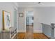 Upstairs hallway with hardwood floors and art on the walls at 2685 Grady Se St, Smyrna, GA 30080