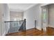 Upstairs hallway with hardwood floors and views to the outside at 2685 Grady Se St, Smyrna, GA 30080