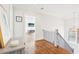 Upstairs hallway with hardwood floors, transom window, and decorative accents at 2685 Grady Se St, Smyrna, GA 30080