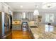 Updated kitchen showcasing stainless steel appliances, granite countertops, and stylish gray cabinetry at 2685 Grady Se St, Smyrna, GA 30080