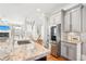 Open kitchen with stainless steel appliances, granite counters, and view of stairs at 2685 Grady Se St, Smyrna, GA 30080