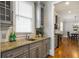 Modern kitchen with gray cabinets, granite countertops, stainless steel sink and view into the breakfast nook at 2685 Grady Se St, Smyrna, GA 30080