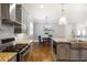Kitchen featuring a center island, stainless steel range, gray cabinets and breakfast nook in the distance at 2685 Grady Se St, Smyrna, GA 30080