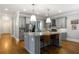 Spacious kitchen with a large center island, stainless steel appliances, and modern pendant lighting at 2685 Grady Se St, Smyrna, GA 30080