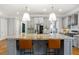 Well-equipped kitchen featuring gray cabinets, granite counters, a large island and stainless steel appliances at 2685 Grady Se St, Smyrna, GA 30080