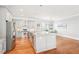 Bright kitchen with stainless steel appliances, gray cabinets, granite countertops, and wood flooring at 2685 Grady Se St, Smyrna, GA 30080