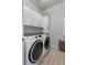 Spacious laundry room with white cabinets, modern washer and dryer, and stylish tiled flooring at 2685 Grady Se St, Smyrna, GA 30080