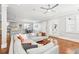 Spacious living room showcases hardwood flooring, gray sectional, and access to kitchen at 2685 Grady Se St, Smyrna, GA 30080