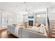 Bright living room with fireplace, hardwood floors, and gray sectional seating near staircase at 2685 Grady Se St, Smyrna, GA 30080