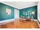 Spacious living room with hardwood floors, dark teal walls, and built-in closet space at 2685 Grady Se St, Smyrna, GA 30080