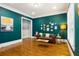 Cozy living room with a leather sofa, a small coffee table, and bold paint, perfect for relaxing at 2685 Grady Se St, Smyrna, GA 30080