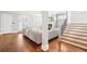 Open-concept living room features hardwood floors, staircase, fireplace, and neutral sectional at 2685 Grady Se St, Smyrna, GA 30080
