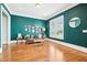 Bright living room with hardwood floors, dark teal walls, and a comfortable seating arrangement at 2685 Grady Se St, Smyrna, GA 30080